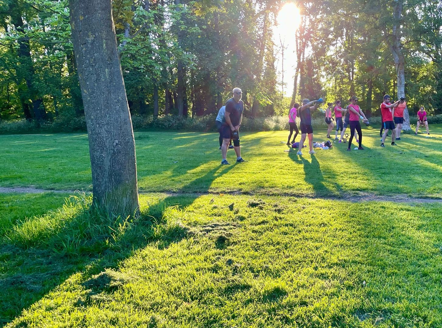 group of people exercising outdoors in a park